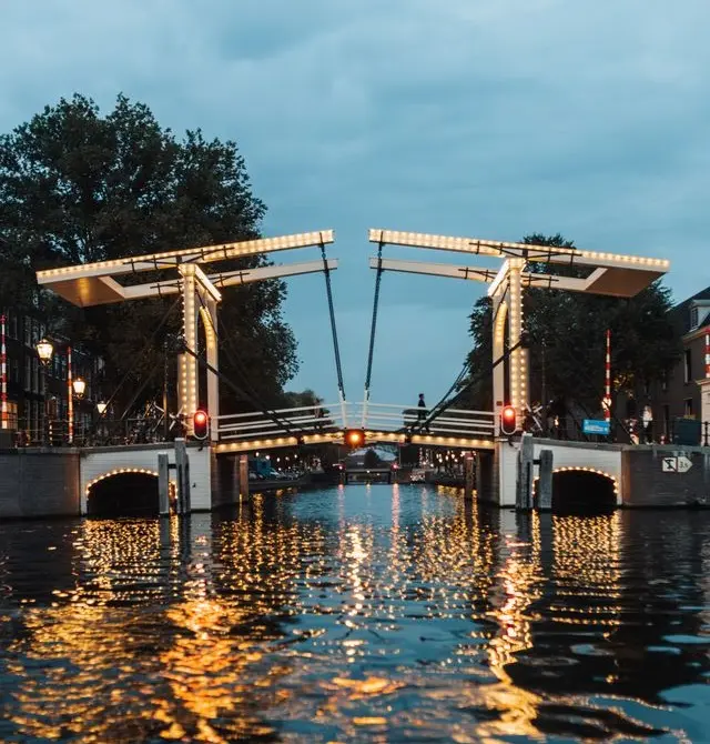 Magere Brug o Puente Delgado iluminado sobre el río Amstel en Ámsterdam